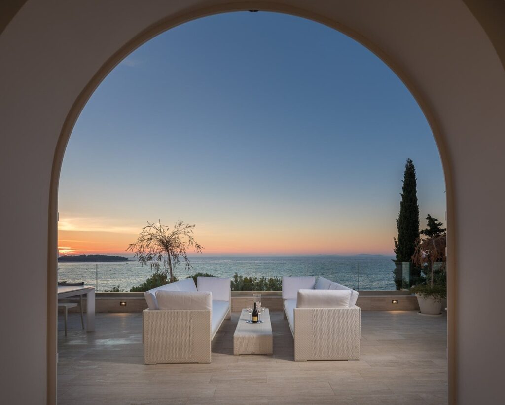 Outdoor seating and lounge area with an ocean view at the Circle of Light villa