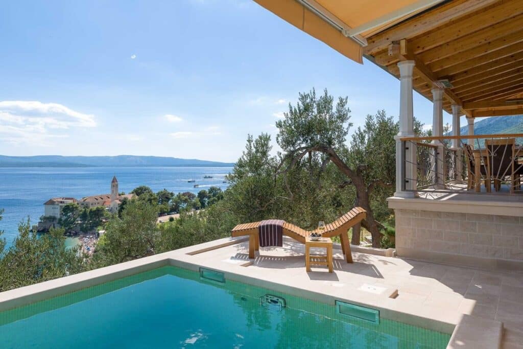 Private pool with a sun lounger and a shaded balcony at the Edge of Dawn villa