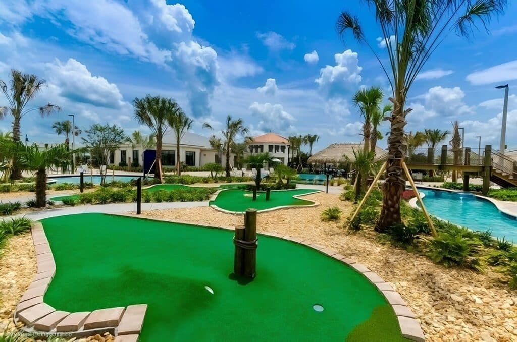 Golf course surrounded by tall palm trees under a clear blue sky at the Fairyland Retreat villa