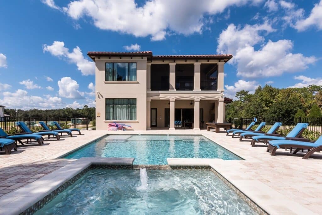 Swimming pool lined with blue sun loungers at the Orlando Thrills villa