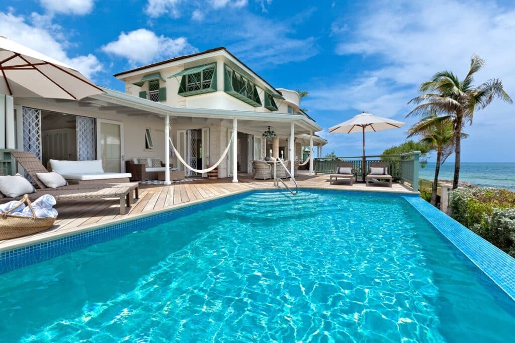 Infinity pool with sun loungers at the Southpoint Surf villa, overlooking the Atlantic Ocean