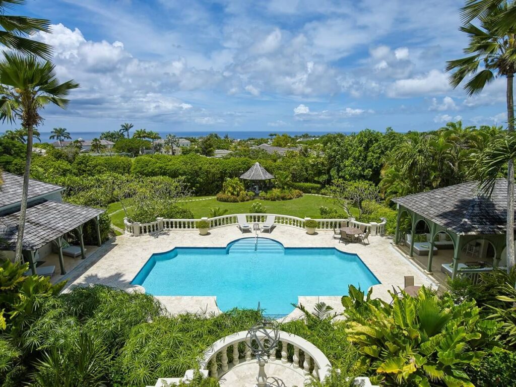 Aerial view of the pool with sun loungers at the Tropical Birds villa with a gazebo