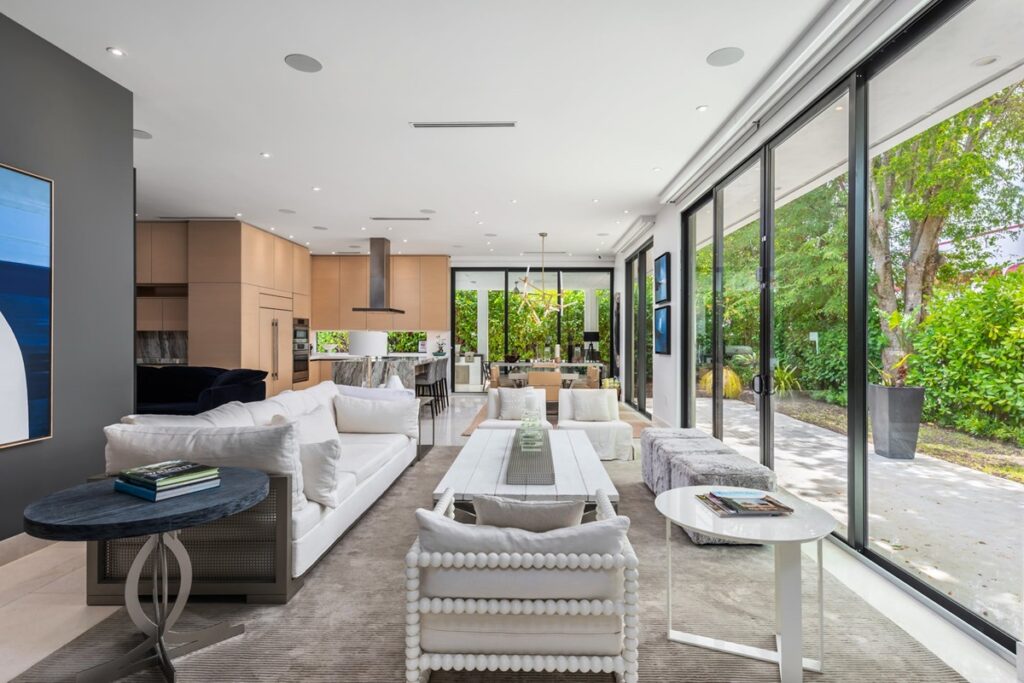 Modern living room with floor-to-ceiling glass windows at the Ultra Oasis villa