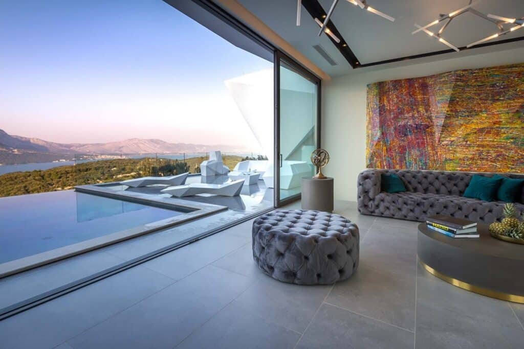 Living room overlooking the infinity pool with a scenic view at Villa Anthurium