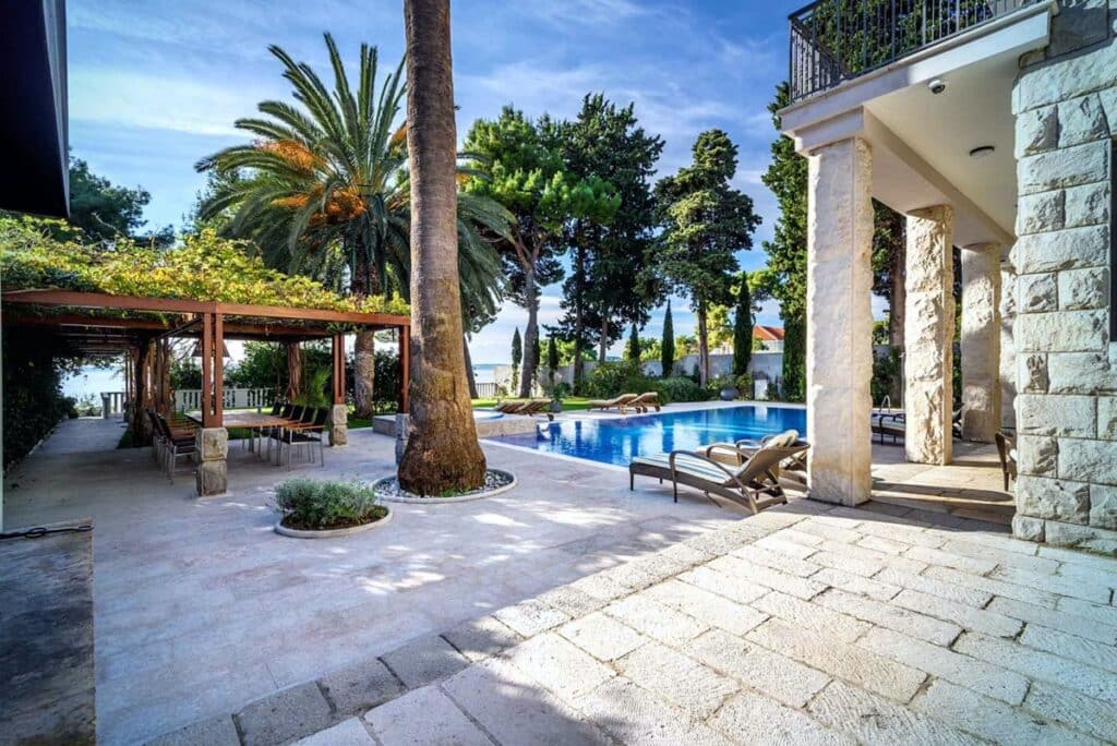 Private pool surrounded by a lush garden at Villa Jaka