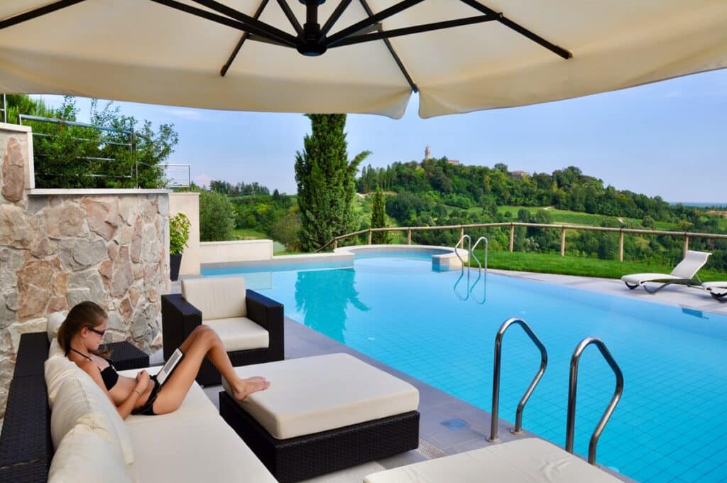 Teenage girl lounging by the villa pool