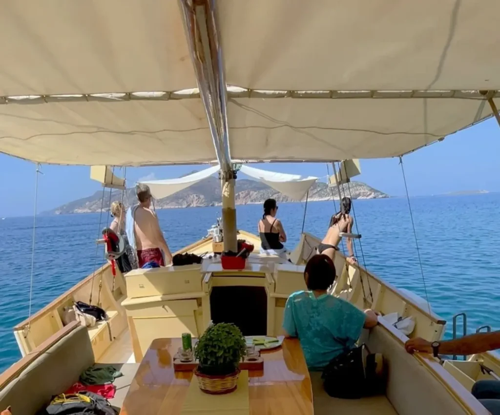 A family enjoying a private boat with clear blue water and island views, during a multi-generational vacation