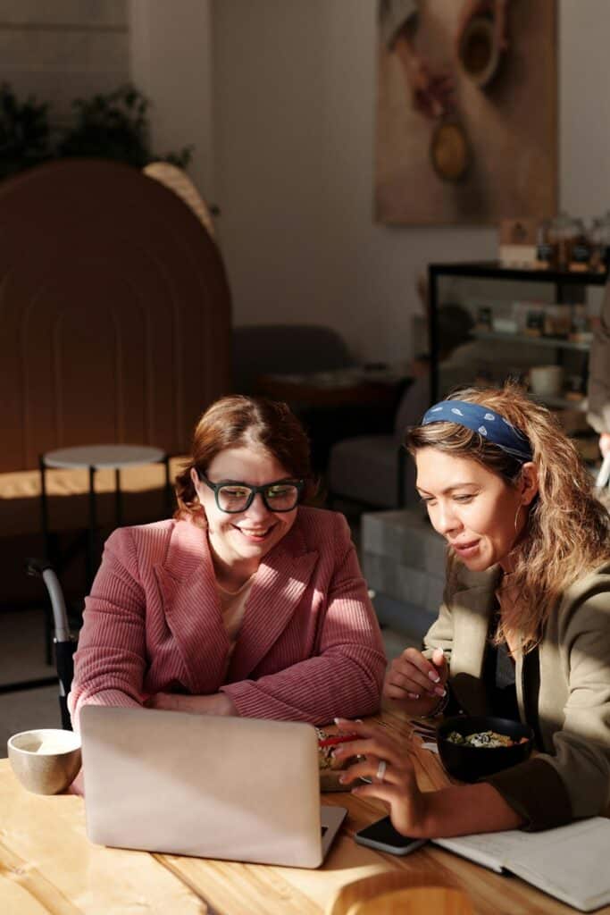 Two women doing research planning for vacation