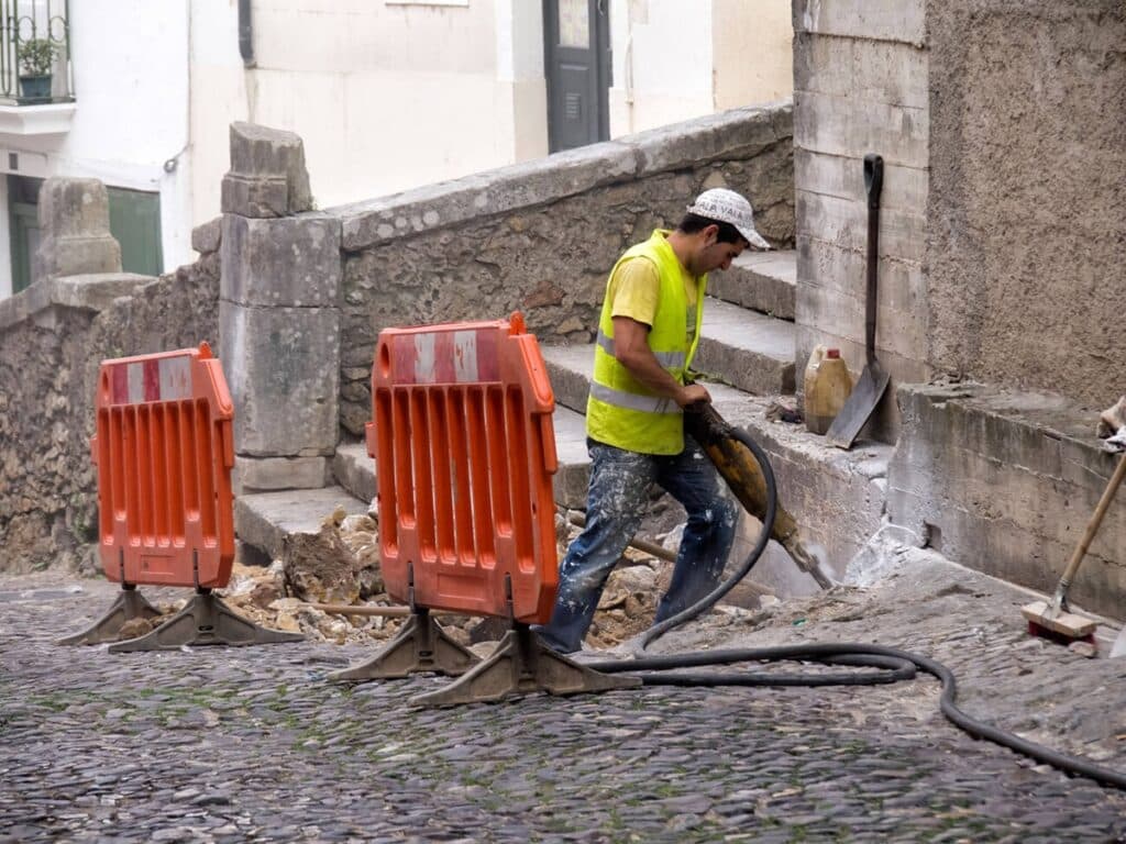 Construction worker with a jackhammer at a construction site.