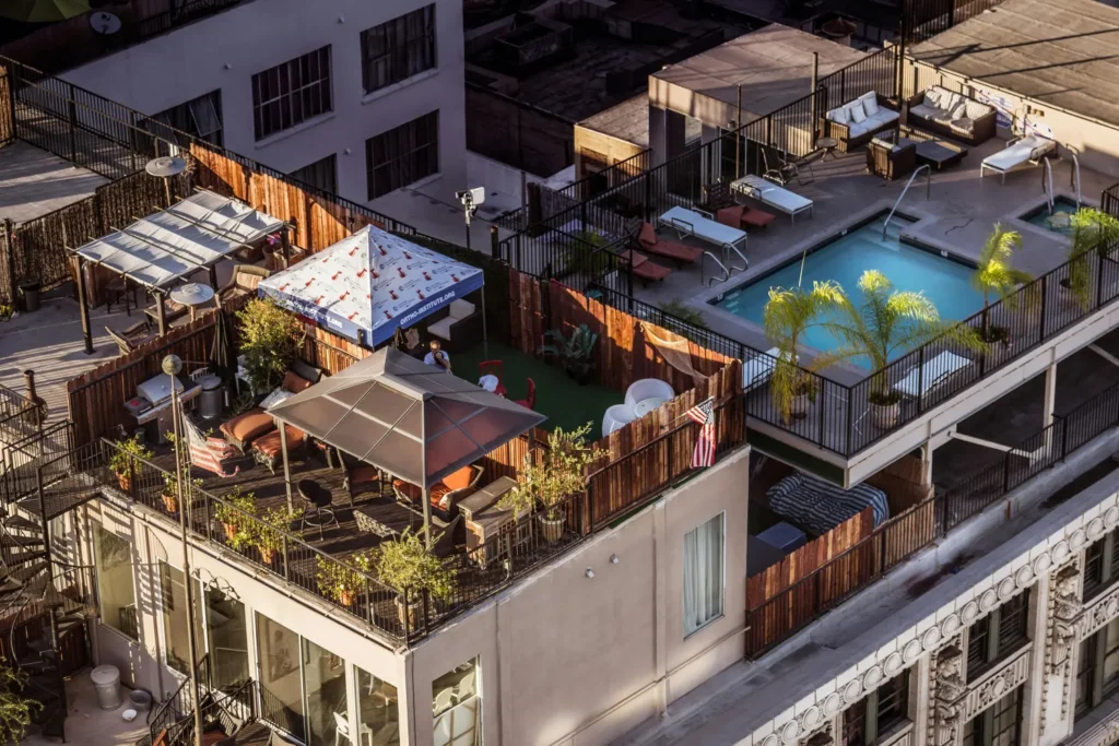 Aerial view of a luxury penthouse with rooftop terraces, lounge areas, and a swimming pool.