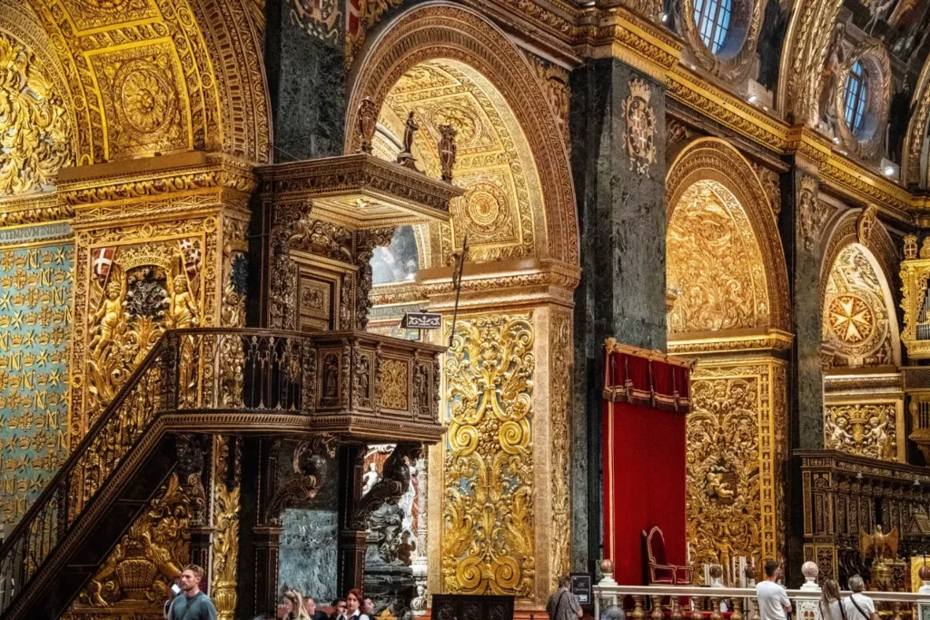 Visitors inside St John’s Co-Cathedral in Valletta, Malta, witnessing the works of Caravaggio.