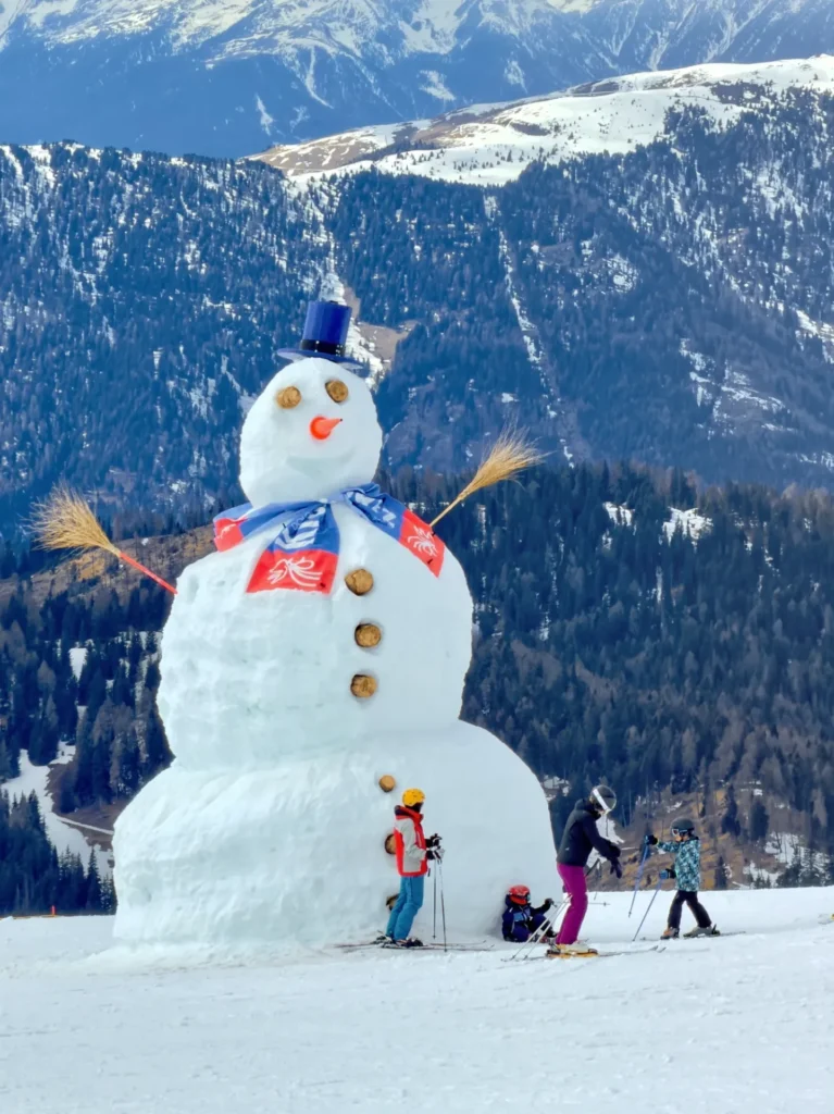 Snowman and skiers