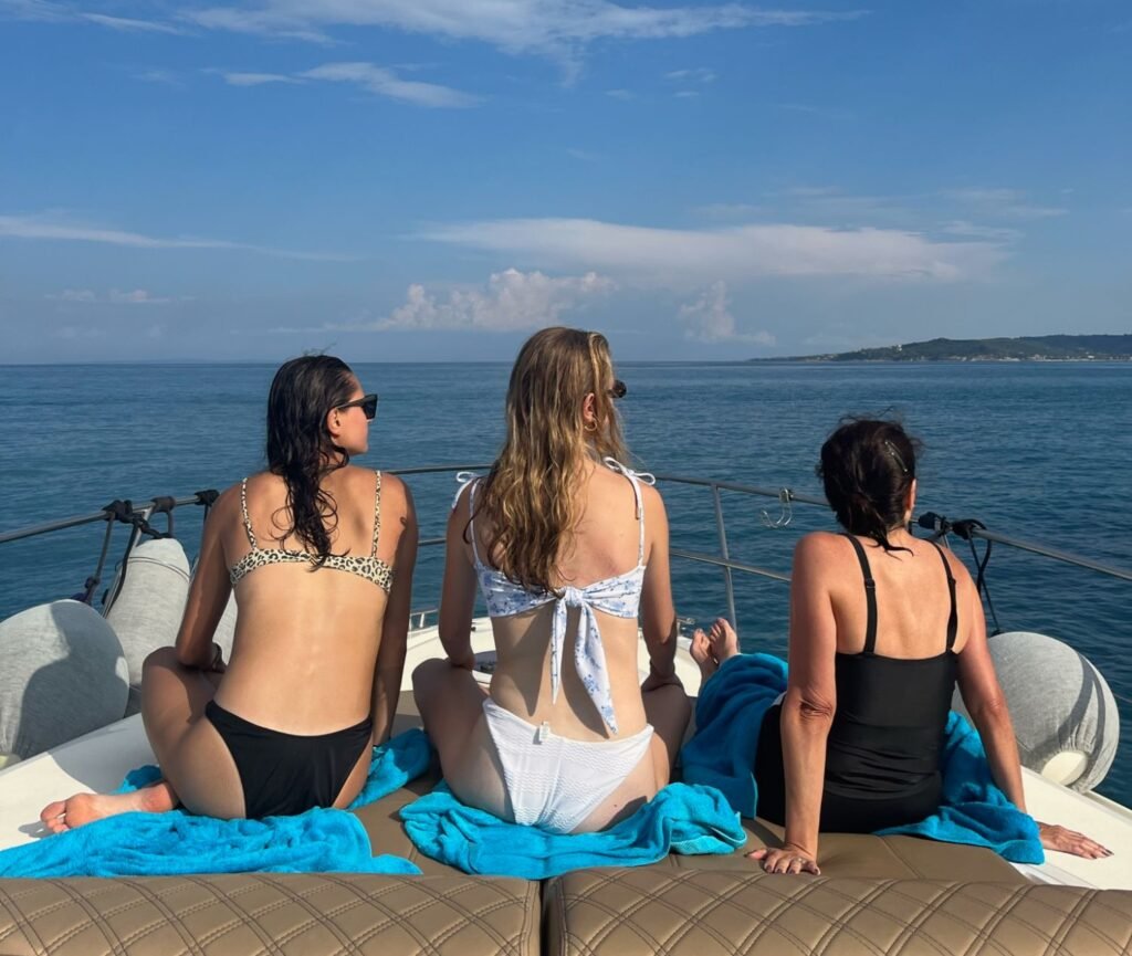 Mother and daughters enjoying an afternoon cruise during a multigenerational family vacation.