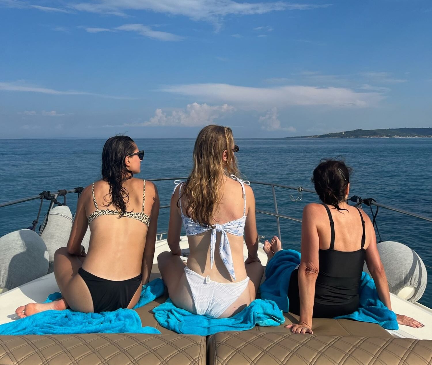 Mother and daughters enjoying an afternoon cruise during a multigenerational family vacation.