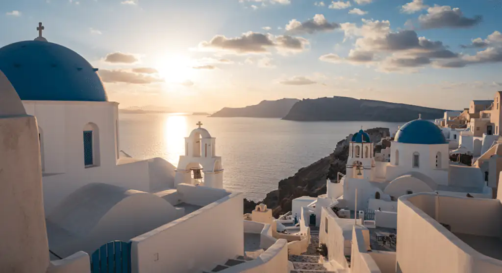 A santorini caldera sunset over whitewashed buildings shows why multi-generational vacations in greece are unforgettable.