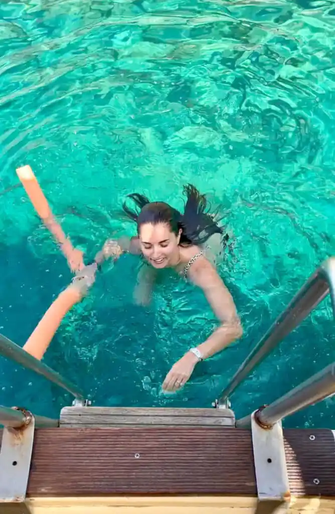 Original photo by paul partridge of a woman swimming in clear turquoise water near the island of antiparos in greece.