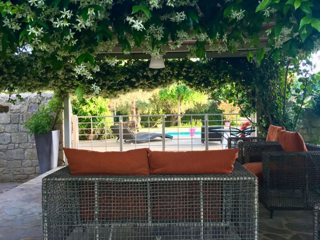 Shaded pergola and pool at a family heritage vacation villa in southeastern Sicily.