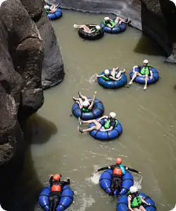 Family members tubing down a river in costa rica during a family reunion vacation.